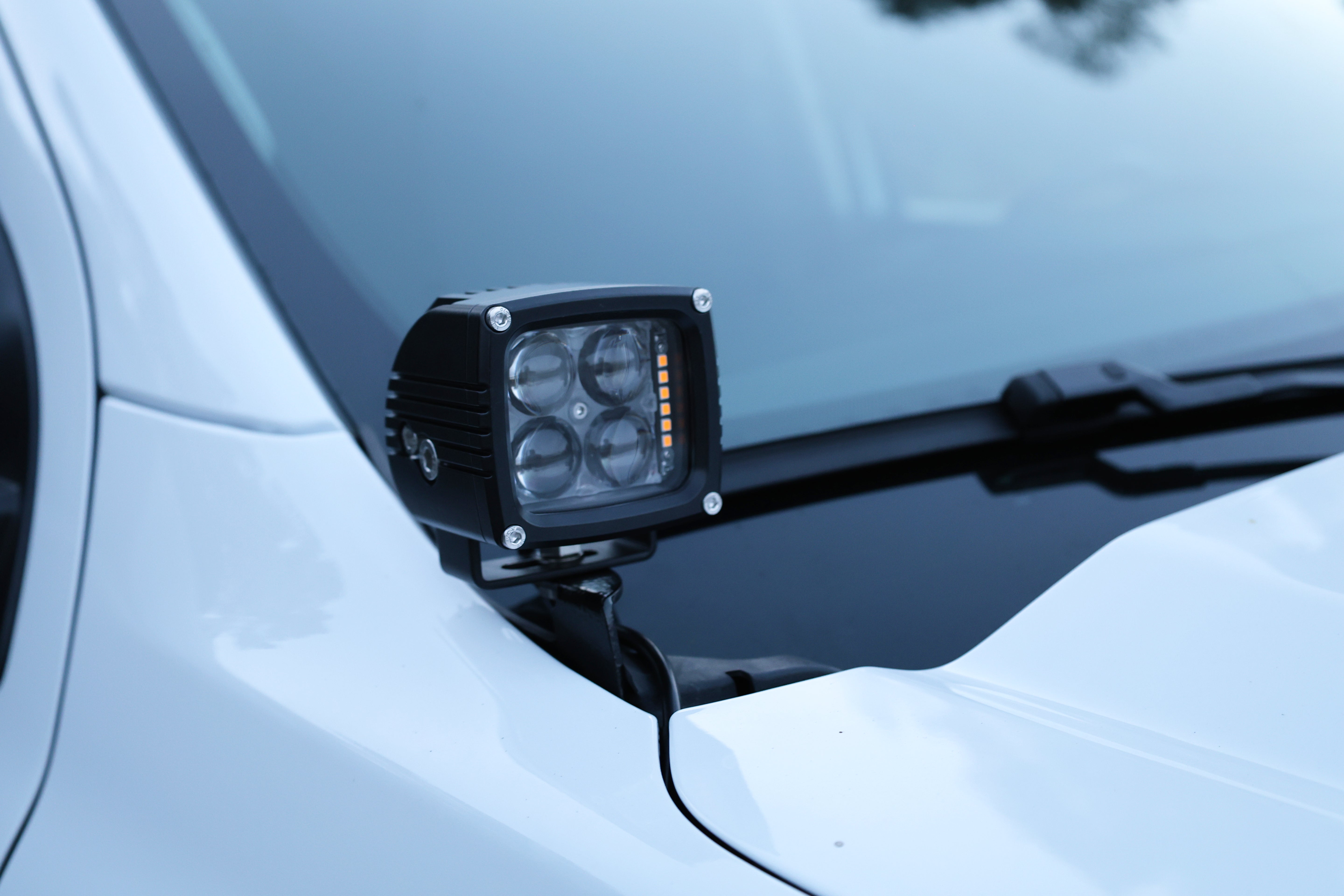 LED ditch light pod mounted at the hood corner of a Ford Ranger for off-road visibility