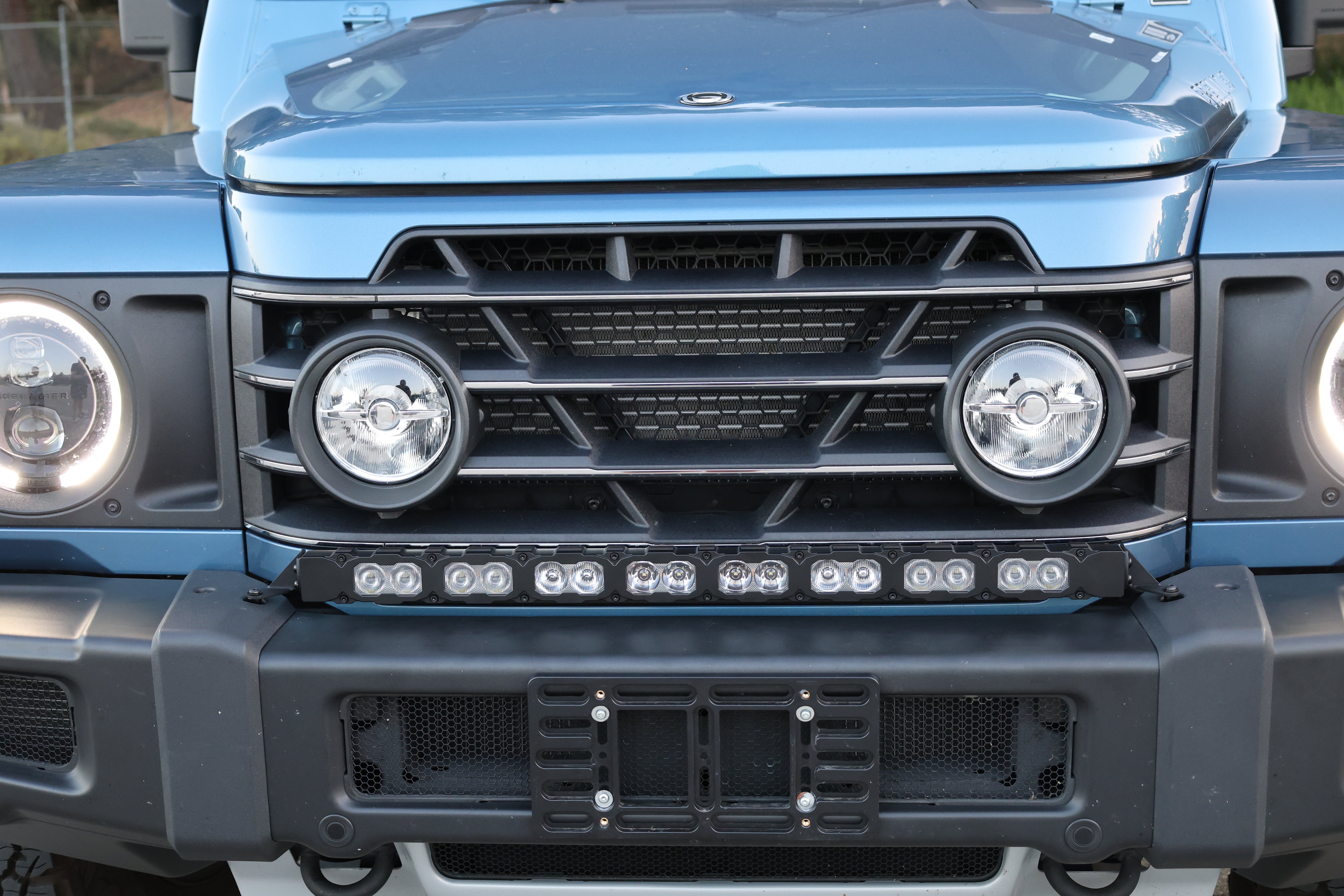 2024+ Ineos Grenadier front corner with halo headlight and 30in black light bar at the bumper