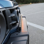2024+ Ineos Grenadier front three-quarter view with slim 30in light bar across the front bumper
