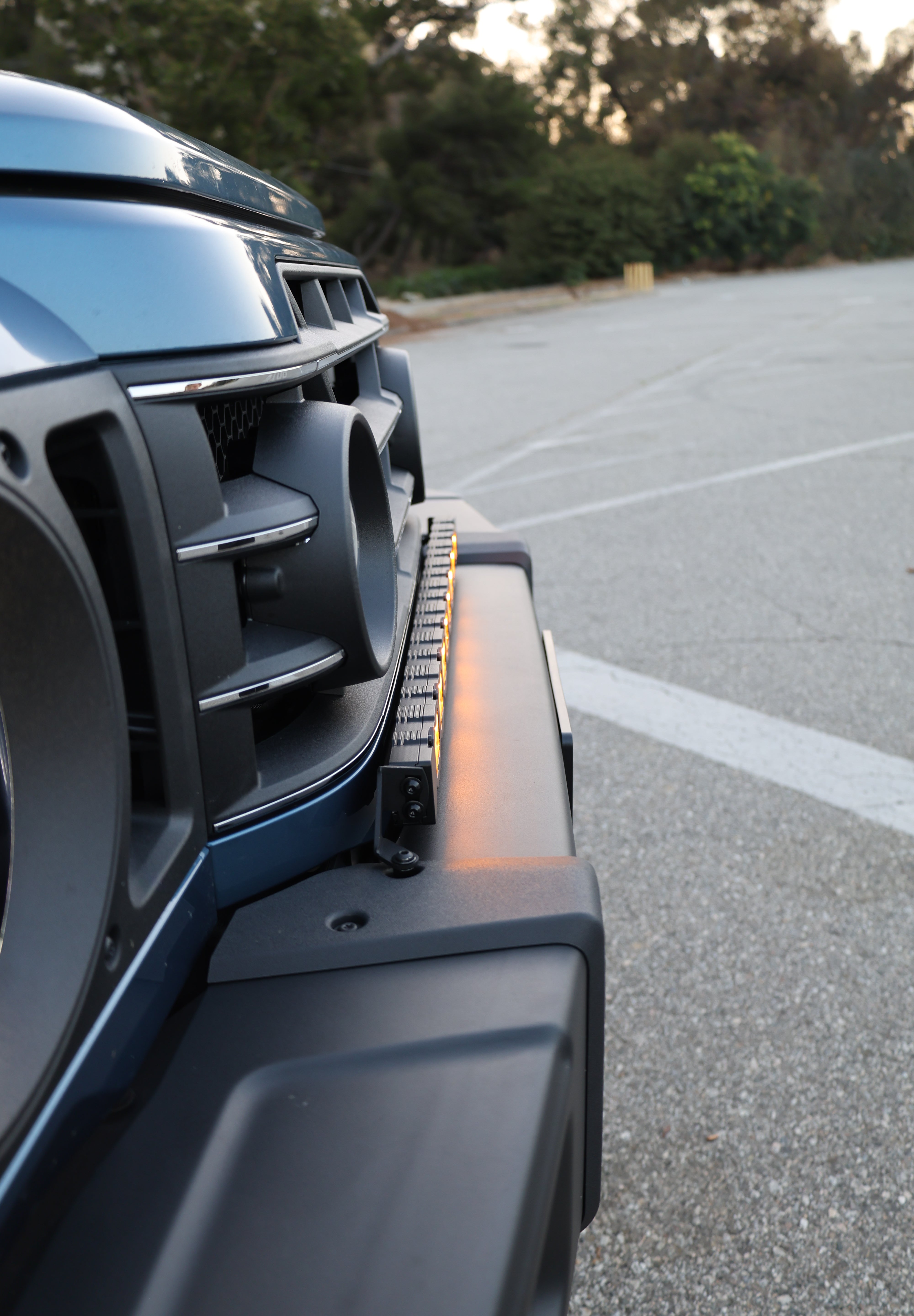 2024+ Ineos Grenadier front three-quarter view with slim 30in light bar across the front bumper