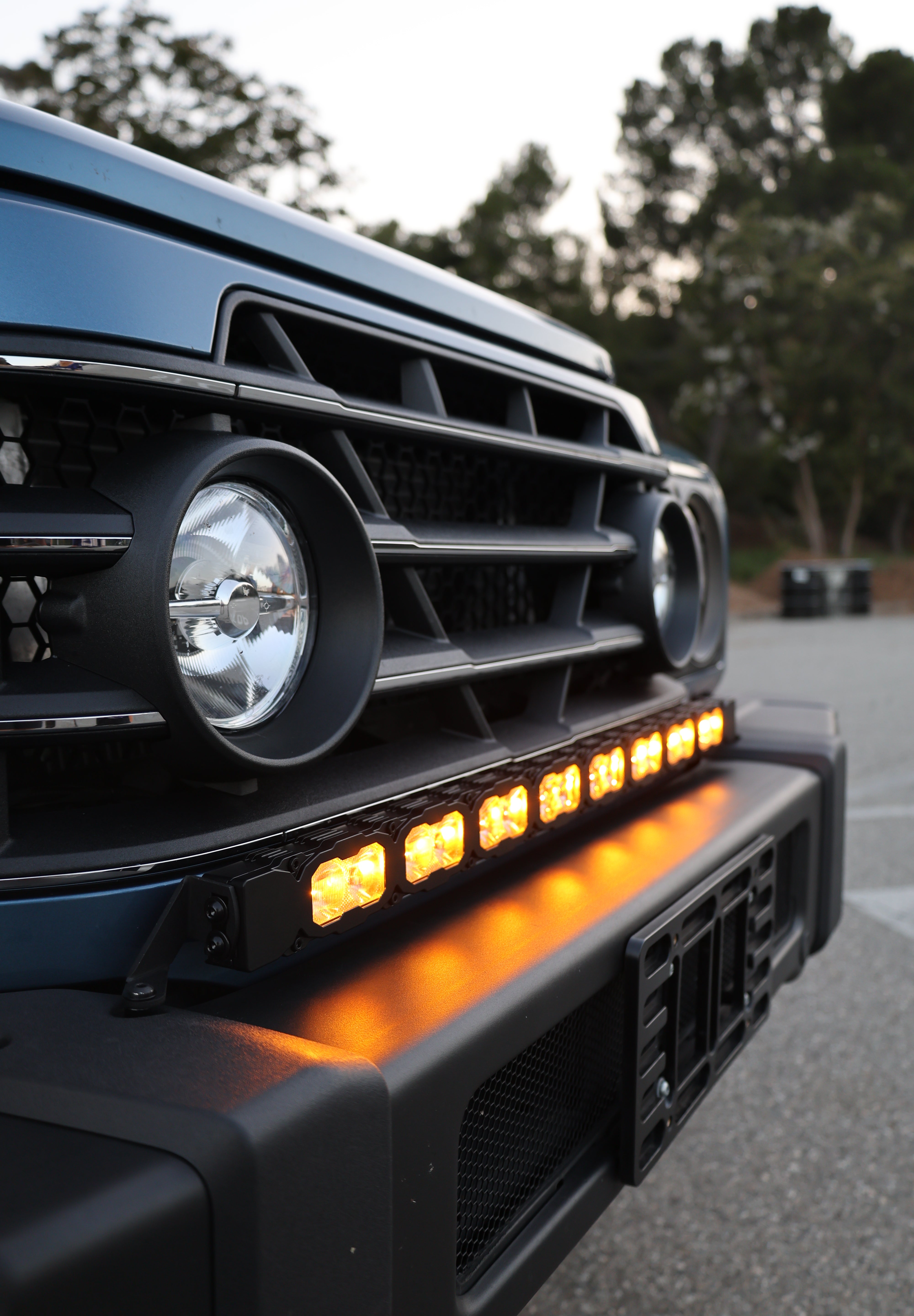 Ineos Grenadier 30in light bar slim black bracket mounted along the top of the front bumper, daylight