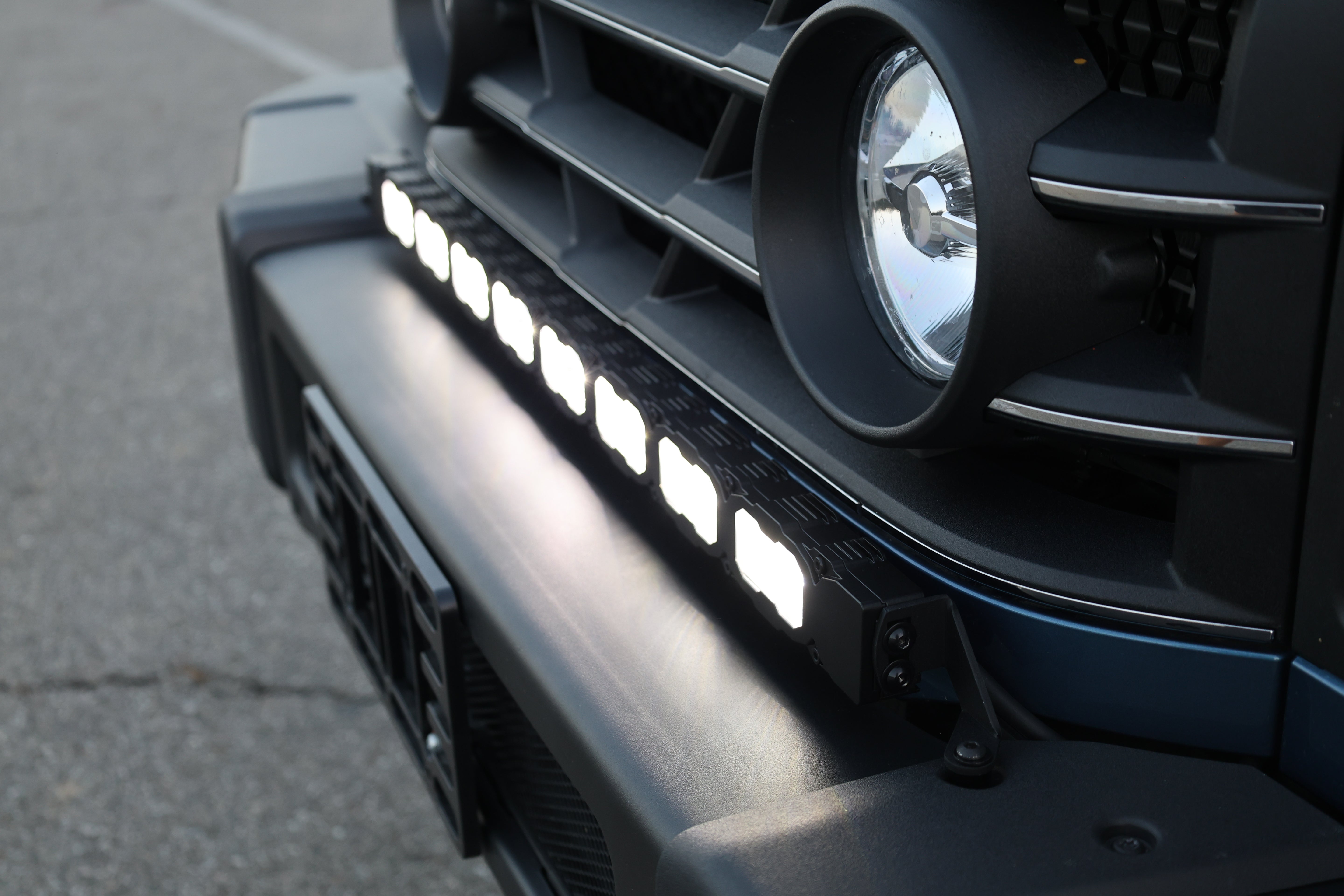 Close-up of the Ineos Grenadier 30in light bar lit in white, TIR LED cubes in black housing