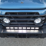 Light-blue 2024+ Ineos Grenadier front corner with 30in bumper light bar and round headlight, daylight