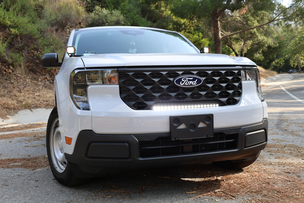 white 2025 ford maverick with led light bar on top of bumper and ditch lighs for off roading