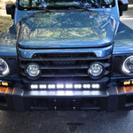 Ineos Grenadier XL light bar kit with the 30in center bar lit white and both 12in extensions showing amber DRL
