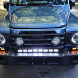 Ineos Grenadier XL light bar kit with the 30in center bar lit white and both 12in extensions showing amber DRL