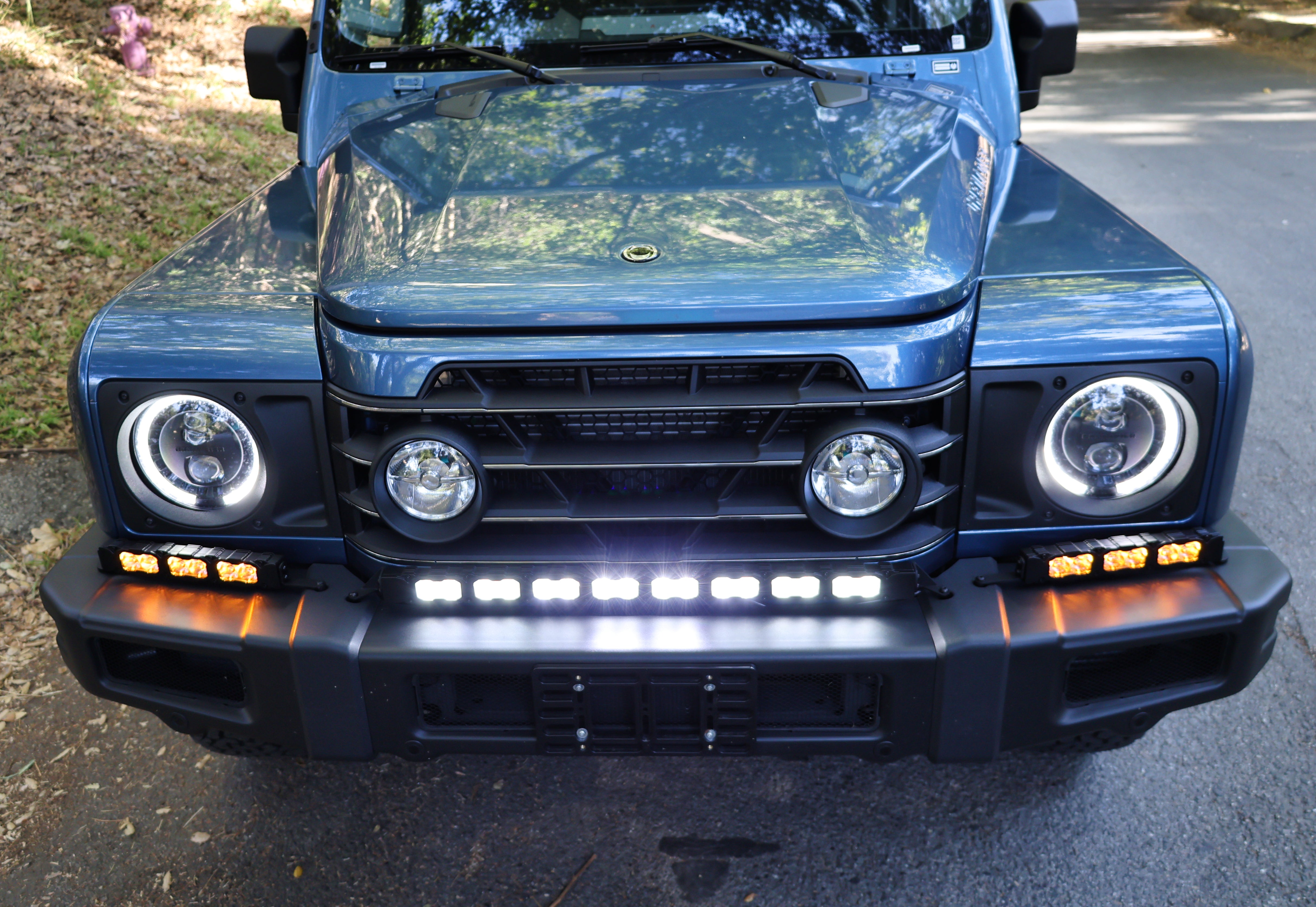 Ineos Grenadier XL light bar kit with the 30in center bar lit white and both 12in extensions showing amber DRL