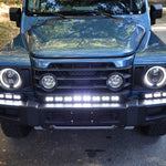 2024+ Ineos Grenadier front view with XL light bar kit lit white, 30in center bar and two 12in extension bars