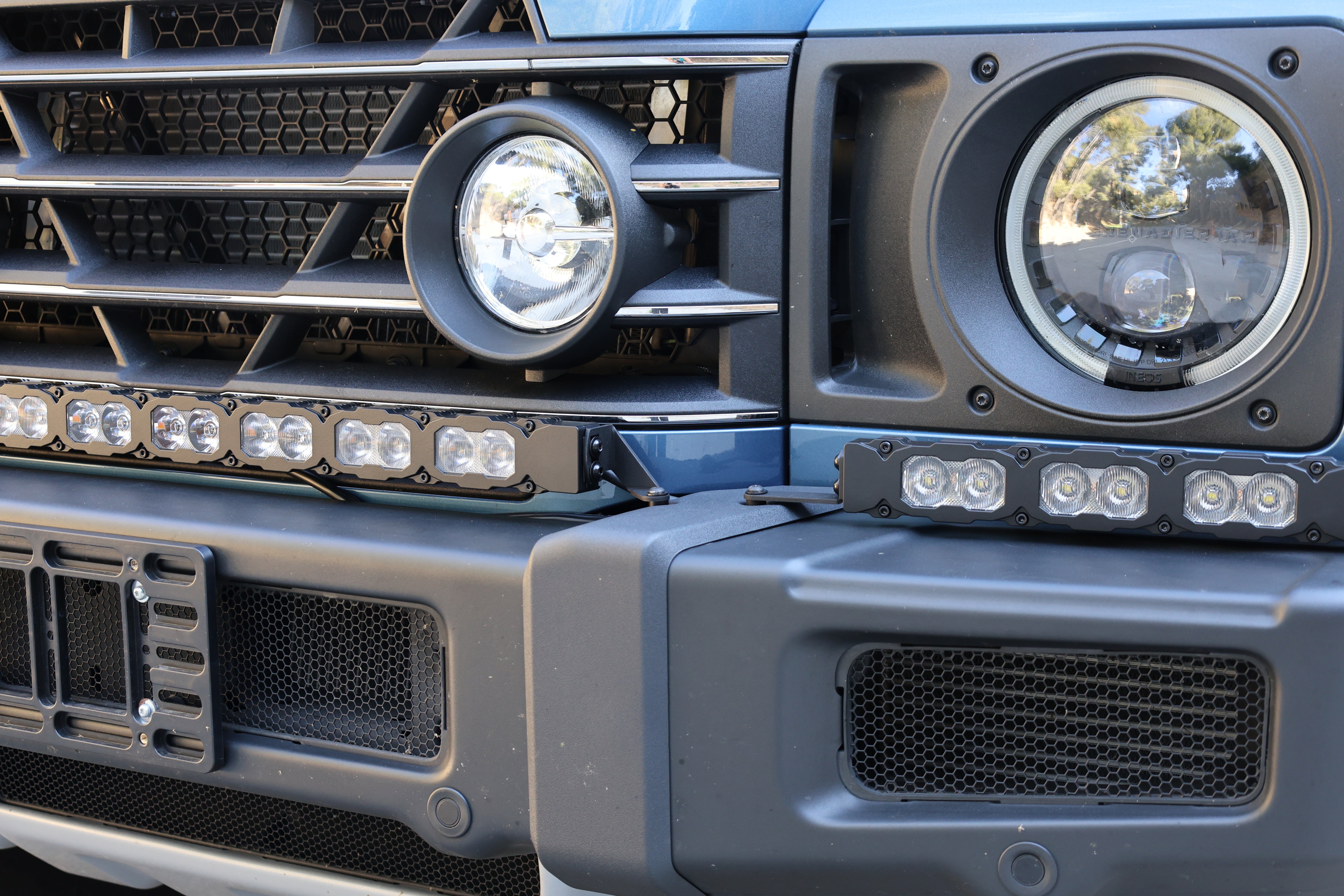 Close-up of the Ineos Grenadier XL light bar kit unlit, showing TIR LED cubes where the 30in and 12in bars meet