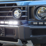Corner close-up of the Ineos Grenadier XL light bar kit lit white, 30in center bar and 12in extension