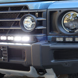 Corner close-up of the Ineos Grenadier XL light bar kit lit white, 30in center bar and 12in extension