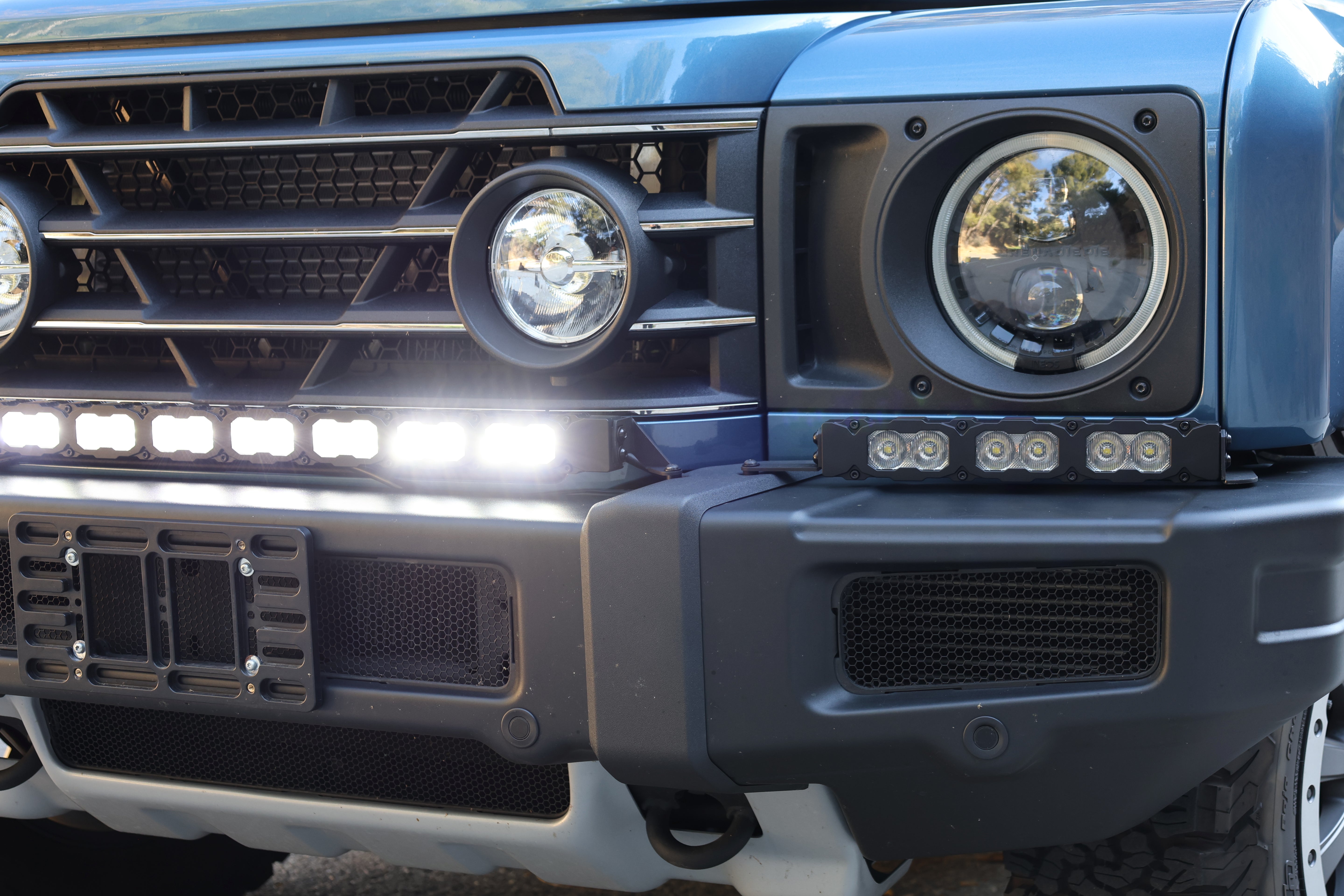 Corner close-up of the Ineos Grenadier XL light bar kit lit white, 30in center bar and 12in extension