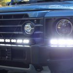 Ineos Grenadier front close-up with XL light bar kit lit bright white, 30in center bar and 12in extension