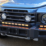 Ineos Grenadier front bumper with the XL light bar kit lit amber, 30in center bar and two 12in extensions