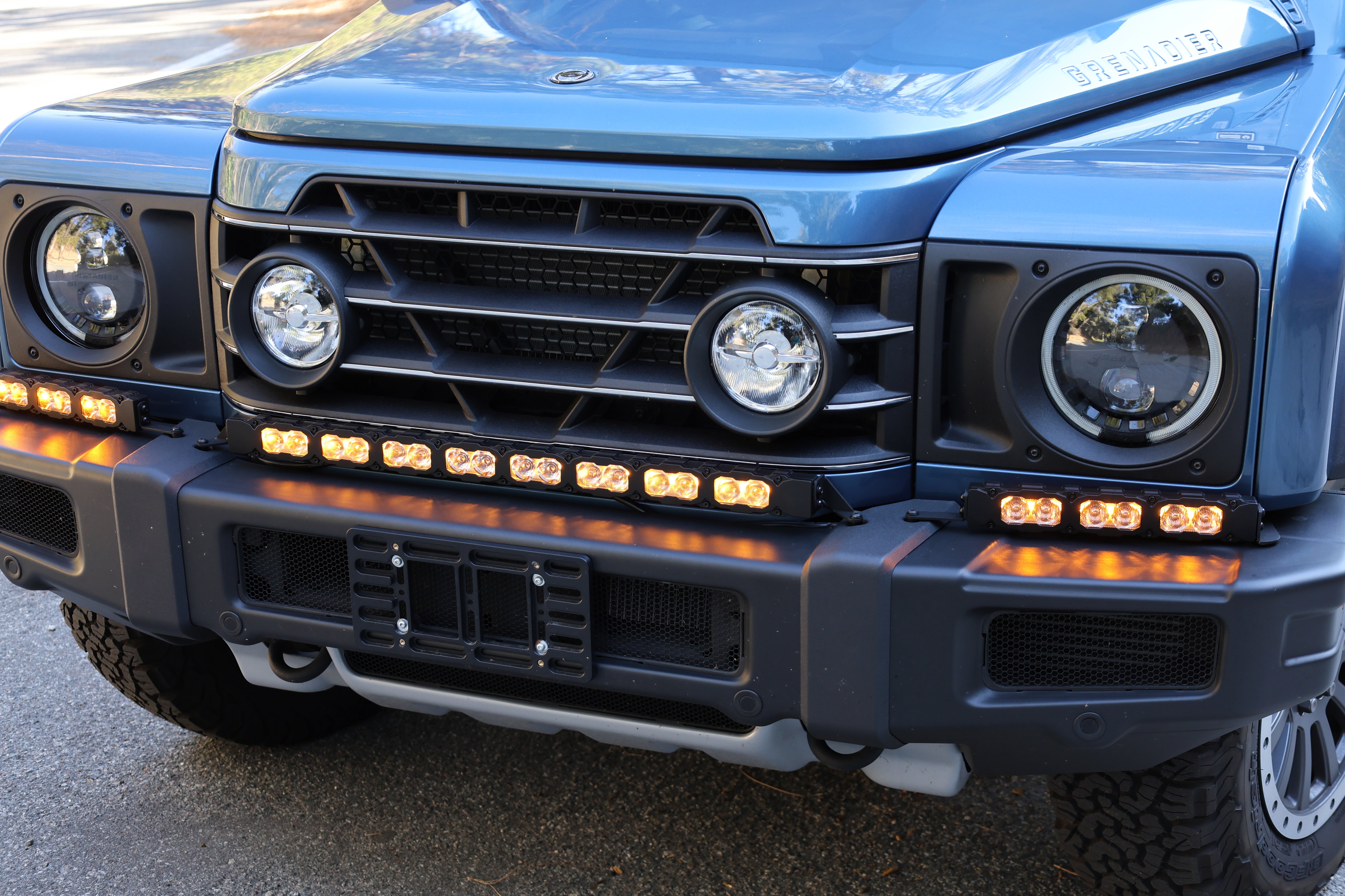 Ineos Grenadier front bumper with the XL light bar kit lit amber, 30in center bar and two 12in extensions