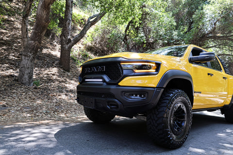 2024 yellow ram trx with m&r automotive off road ditch lights white light bar and fog lights for off roading