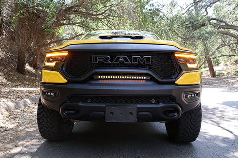 2024 yellow ram trx front view of light bar on top of bumper for off roading and fog lights