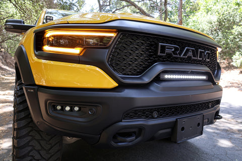 2024 yellow ram trx with m&r automotive off road white light bar on top of bumper