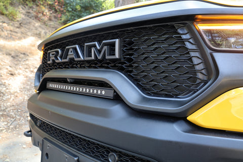 side view of yellow ram trx grille with light bar for off roading