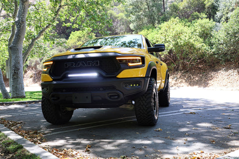 2024 yellow ram trx with m&r automotive off road ditch lights, white light bar and fog lights for off roading