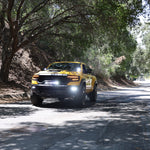 RAM TRX Lightbar 23in PRO installed on yellow RAM 1500 TRX driving on shaded forest road