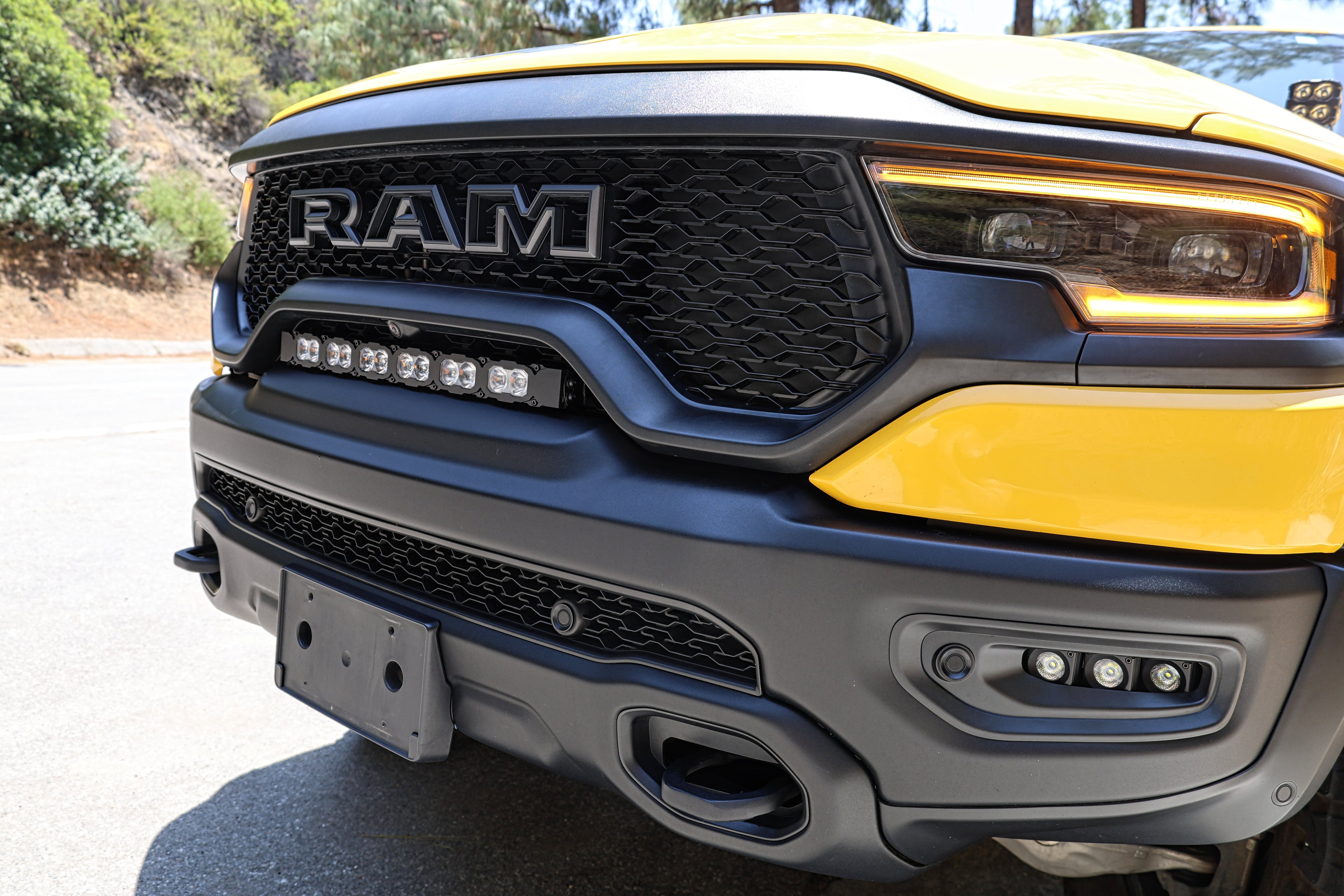 RAM TRX Lightbar 23in PRO mounted between grille and bumper on yellow 2021-2024 RAM 1500 TRX front view