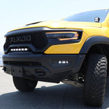 Close-up of the 2019-2024 RAM 1500 TRX fog light kit with three white LED pods lit in the front bumper of a yellow TRX