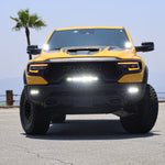 RAM TRX Lightbar 23in PRO installed on yellow 2021-2024 RAM 1500 TRX front view with curved LED light bar illuminated