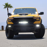 RAM TRX Lightbar 23in PRO installed on yellow 2021-2024 RAM 1500 TRX front view with curved LED light bar illuminated