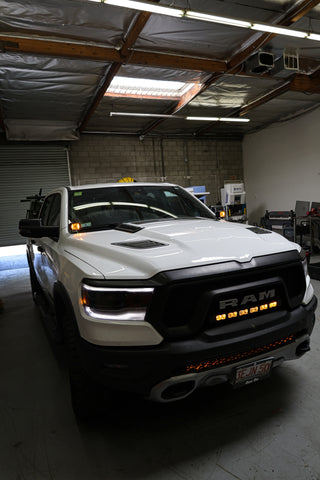 white 2023 ram 1500 rebel with light bar for off roading m&R automotive