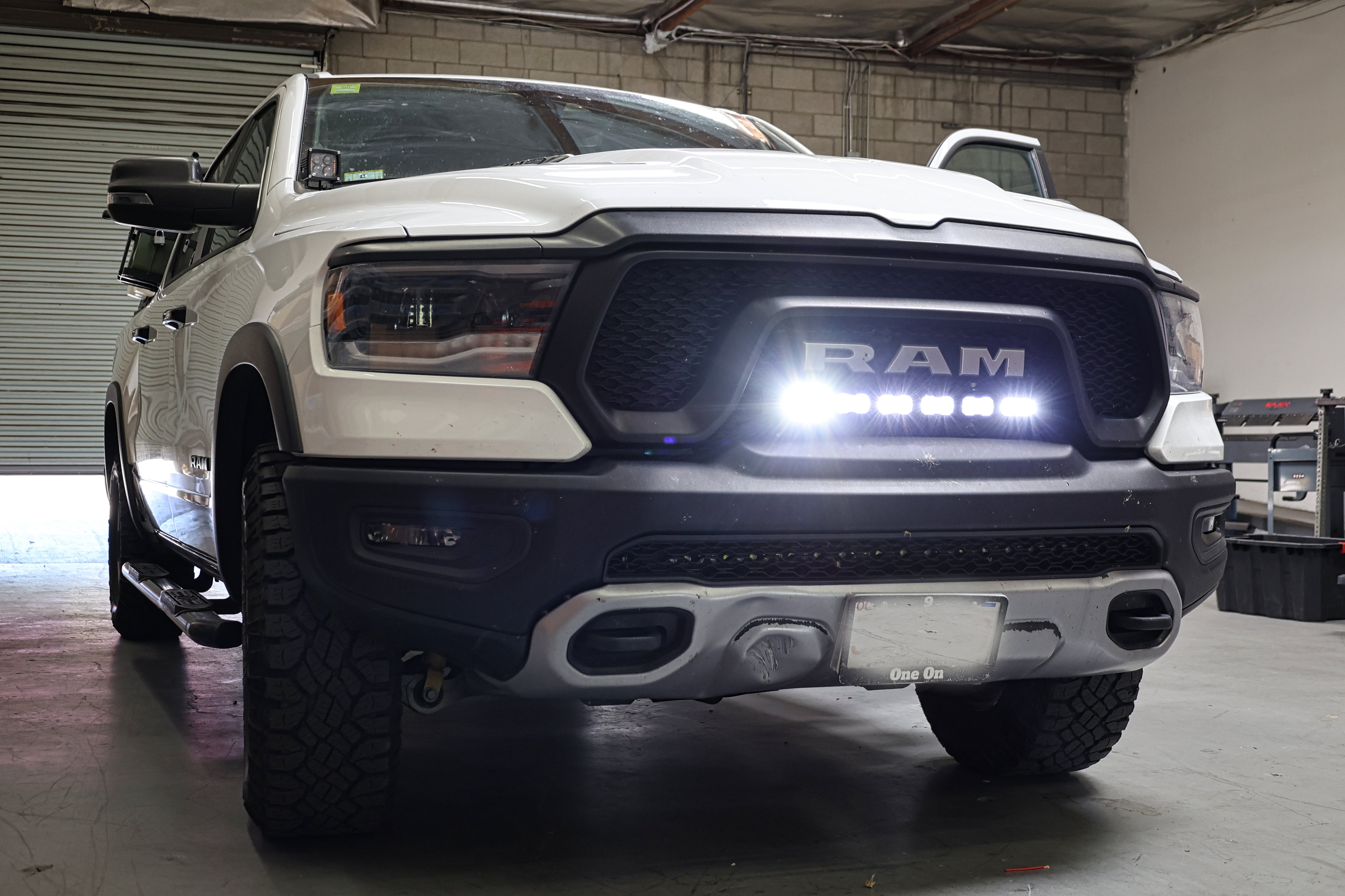 white ram 1500 rebel with light bar for off roading m&R automotive