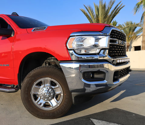 upclose view of 2023 red Ram 2500 HD with LEd light bar on top of bumper for off roading 