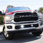 Alt Tag: RAM 2500 lightbar Bumper Light kit installed on 2019-2024 RAM 2500 HD with bright lower grille LED light pods on city street