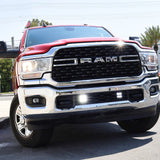 Alt Tag: RAM 2500 lightbar Bumper Light kit installed on 2019-2024 RAM 2500 HD with bright lower grille LED light pods on city street