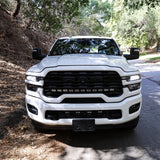 2025+ RAM 2500 Light kit lower grille pods installed on white RAM 2500 truck front view on forest road
