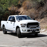 RAM 2500 Fog Light Kit installed on white RAM 2500 truck, bright LED fog lights illuminated on front bumper