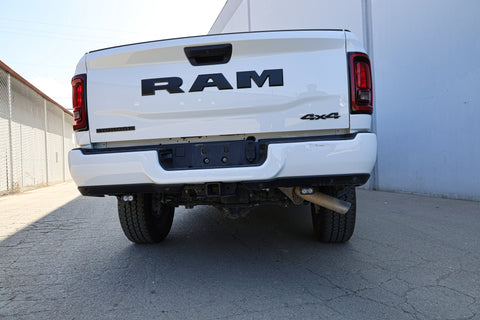 White Ram truck parked on a concrete surface with a white wall in the background with reverse light kit