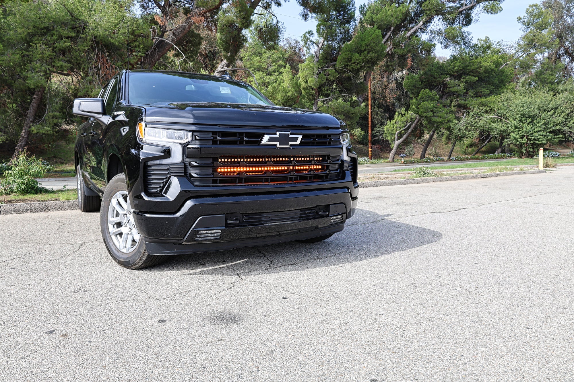 Black Chevrolet Silverado 1500 dual 40in LED light bars, close-up of grille mount