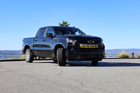 black chevrolet silverado 1500 with led off road light bars behind the grille