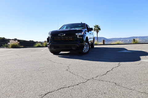 black chevrolet silverado 1500 with led off road light bars behind the grille