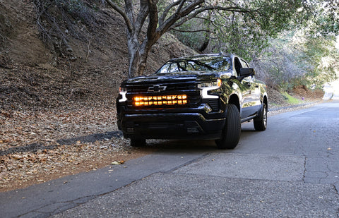 2022 black chevrolet silverado 1500 with led off road light bars behind the grille