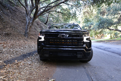 2021 black chevrolet silverado 1500 with led off road light bars behind the grille
