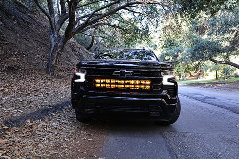 black chevrolet silverado 1500 with led off road light bars behind the grille