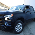 Silverado 1500 ditch lights installed on black 2022+ Chevrolet Silverado 1500 parked outside warehouse