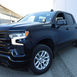 Silverado 1500 ditch lights installed on black 2022+ Chevrolet Silverado 1500 parked outside warehouse