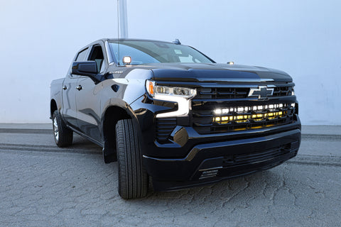 black chevrolet silverado 1500 with led off road light bars behind the grille and ditch lights