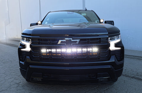 2022 black chevrolet silverado 1500 with led off road light bars behind the grille and hood mount kit