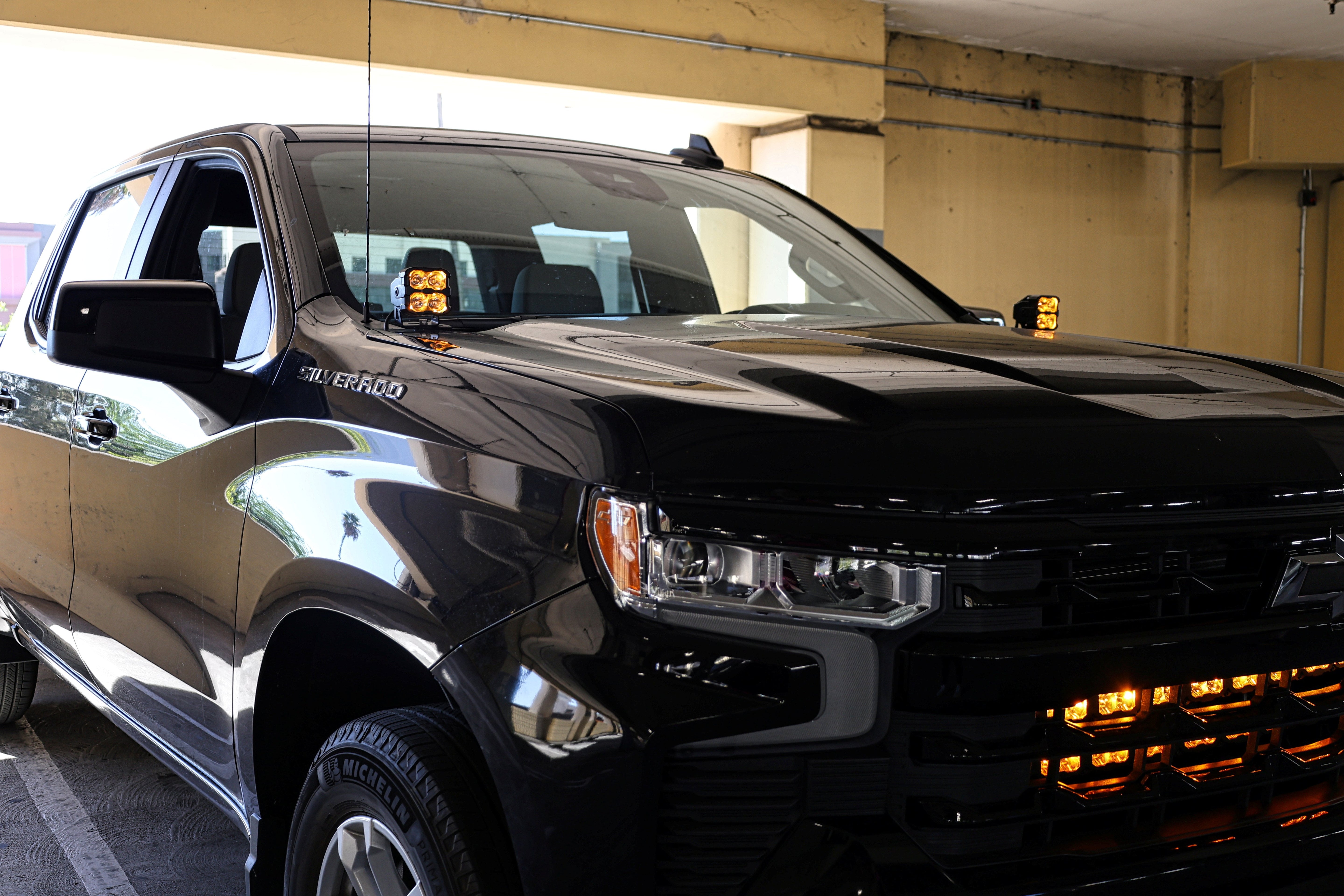 Silverado 1500 ditch lights PRO dual color LED ditch lights installed on 2022+ Chevrolet Silverado 1500 in parking garage