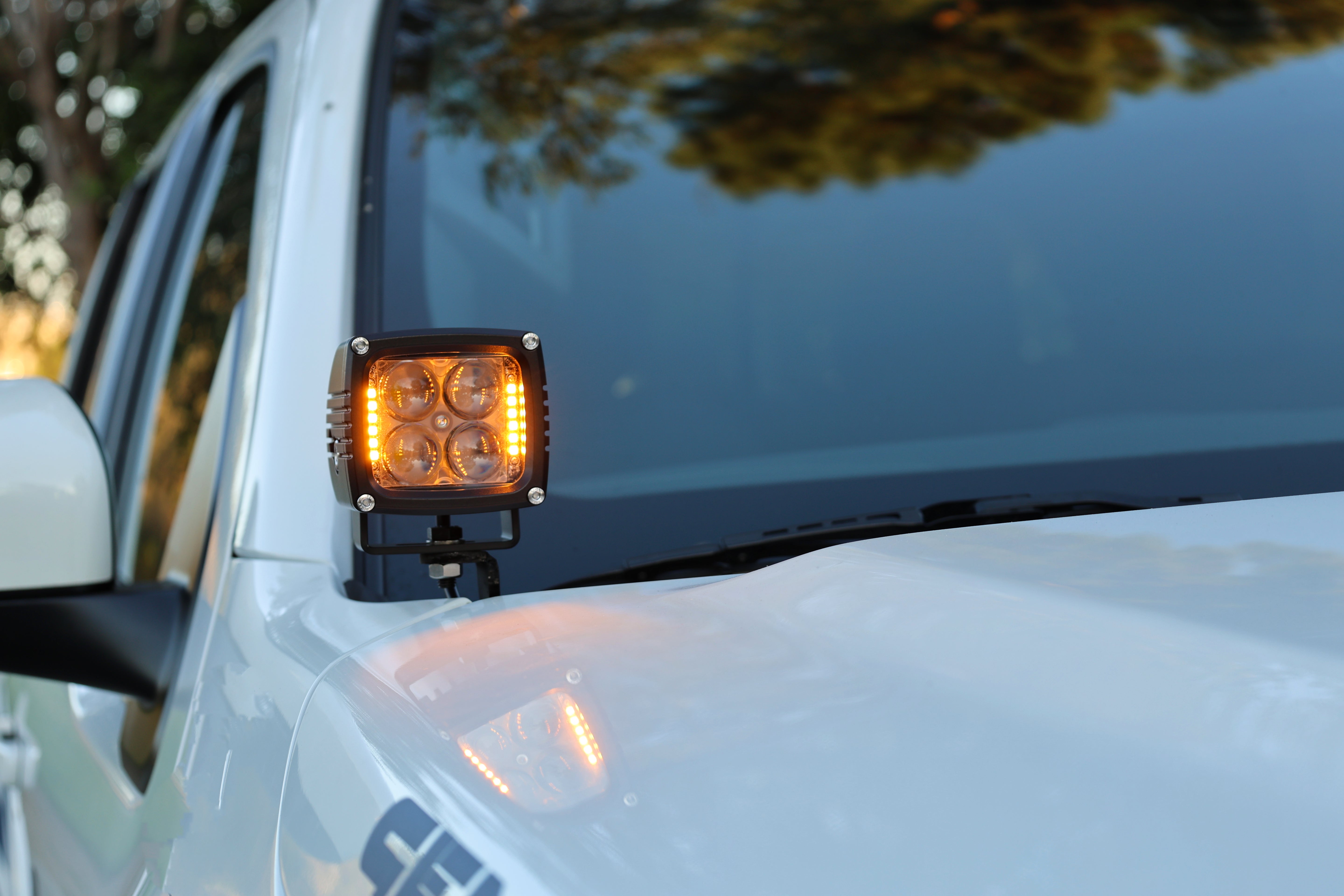 2025+ Nissan Frontier LED ditch lights on a white truck, front view