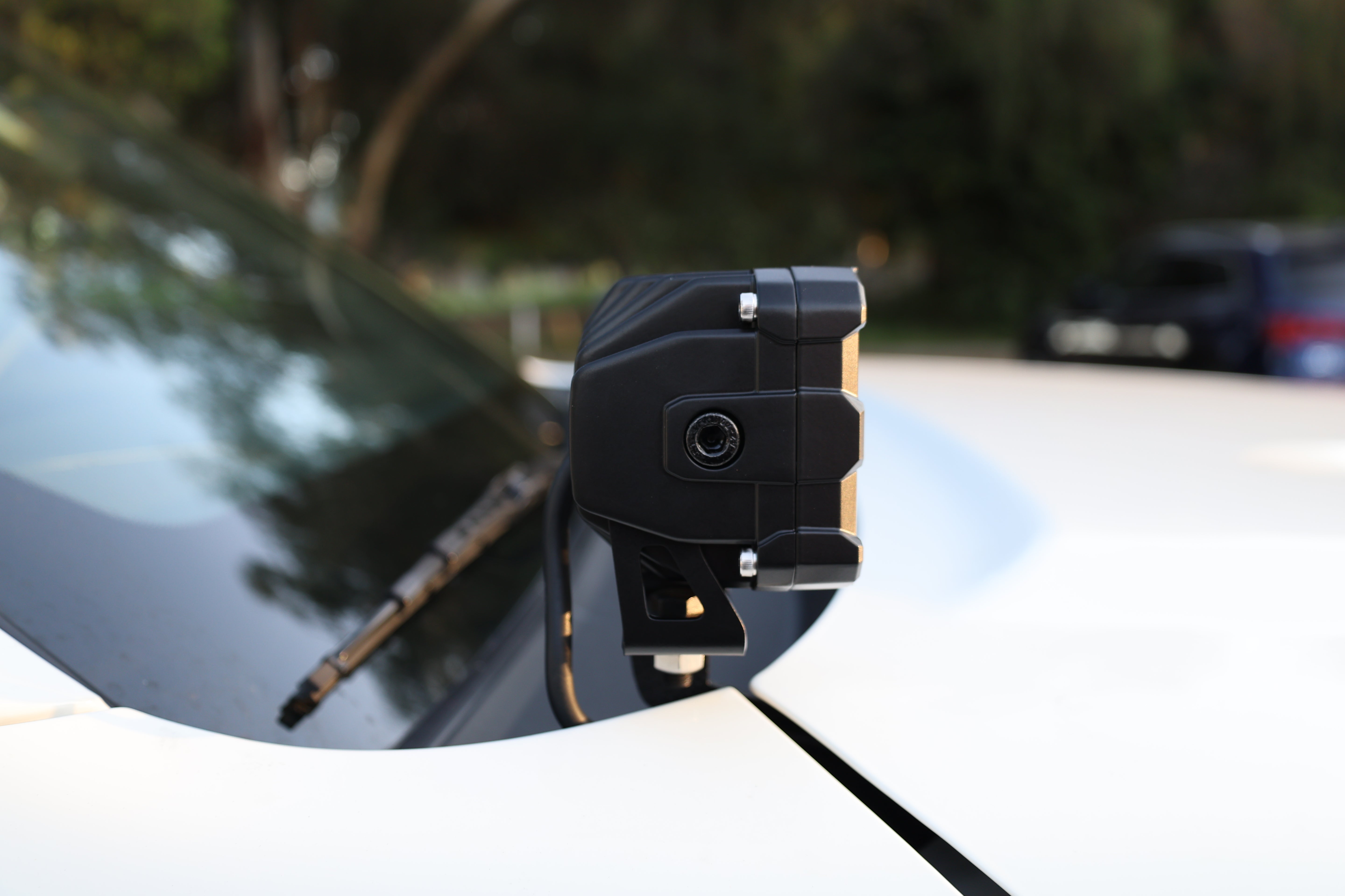 Close-up of a 2025 Nissan Frontier ditch light mounted on a vehicle's hood.